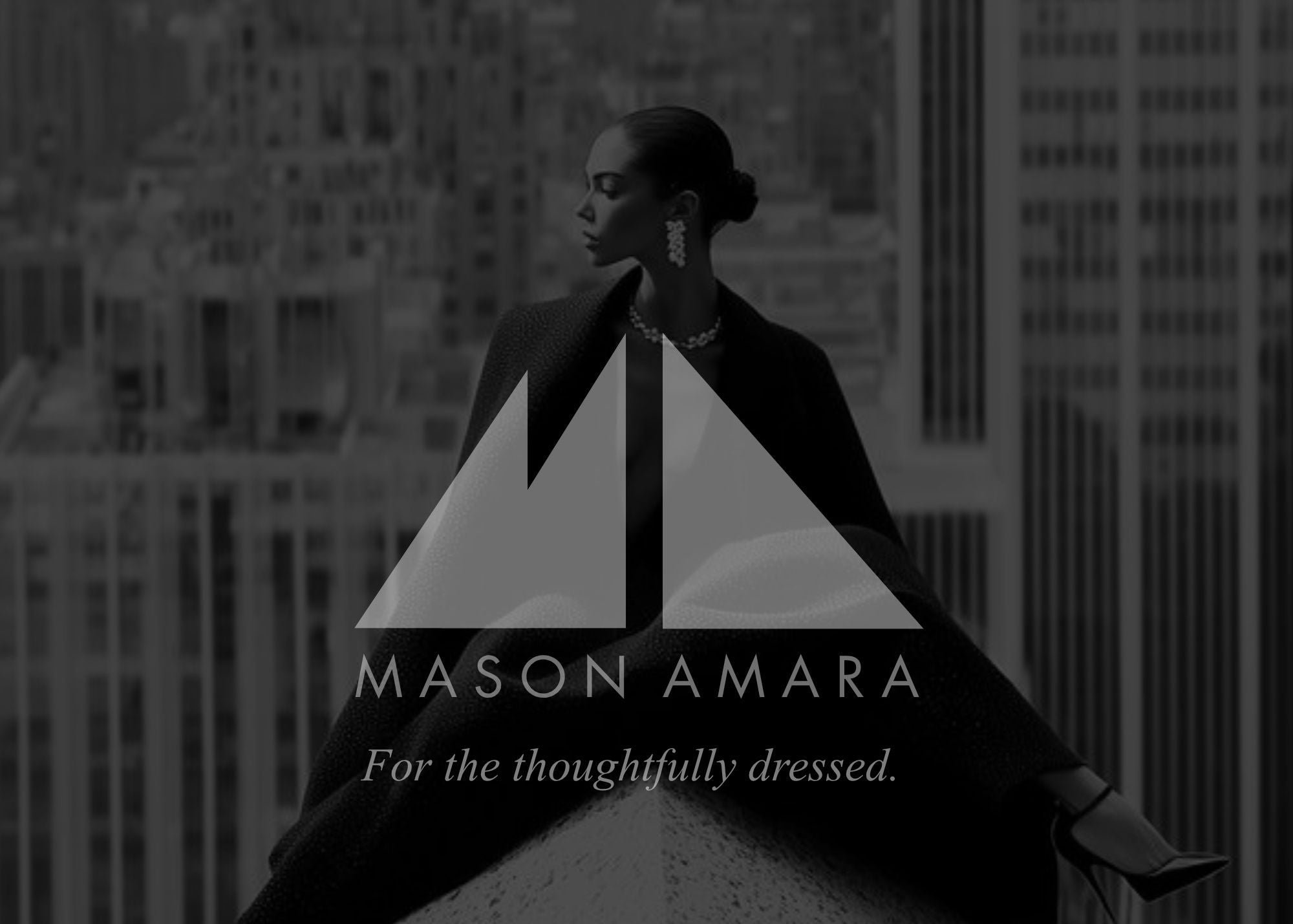 A black and white editorial-style photo of a woman seated on a rooftop with a city skyline behind her. A large white geometric logo and the text 'MASON AMARA For the thoughtfully dressed.